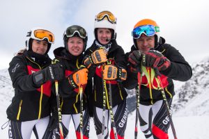 Die vier stehenden Skifahrer in Nahaufnahme mit Ihren Leki Stöcken und Ziener Handschuhen